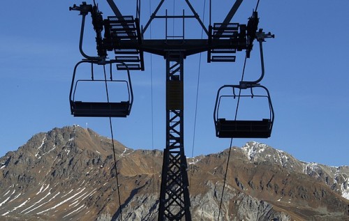 A ski-lift is seen in front of the snowless Swiss Alps during sunny autumn weather in Lenzerheide