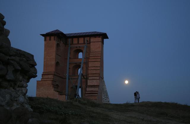 A perigee moon, also known as a super moon, rises above the remains of a medieval fortress in the town of Novogrudok, 150 kilometers (93 miles) west of the capital Minsk, Belarus, Saturday, Aug. 29, 2015. The supermoon happens when moon is full and makes it closest approach to Earth in her orbit. (ANSA/AP Photo/Sergei Grits)