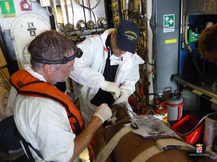 Un migrante ferito viene stabilizzato a bordo di nave Grecale, impegnata nelle operazioni di soccorso ai migranti nel Canale di Sicilia, 26 agosto 2015. +++ ANSA PROVIDES ACCESS TO THIS HANDOUT PHOTO TO BE USED SOLELY TO ILLUSTRATE NEWS REPORTING OR COMMENTARY ON THE FACTS OR EVENTS DEPICTED IN THIS IMAGE; NO ARCHIVING; NO LICENSING +++