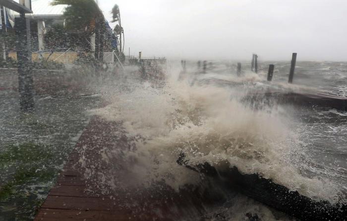 Surf from the Banana River crashes up on a dock at Sunset Grill in Cocoa Beach, Fla., as Hurricane Matthew hits Florida's east coast, Friday, Oct. 7, 2016. (Red Huber/Orlando Sentinel via AP)